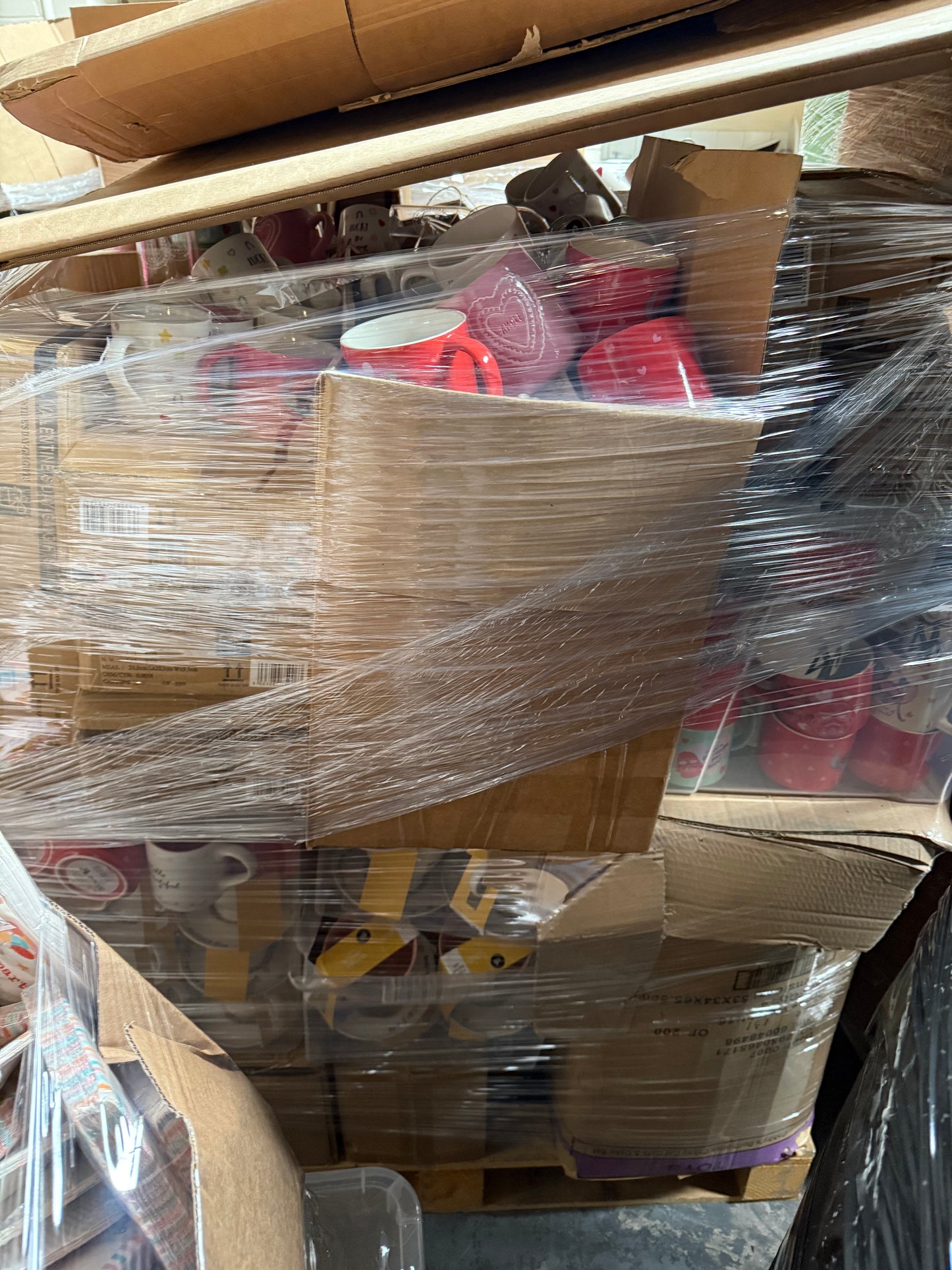 Stacked boxes of seasonal mugs wholesale pallet wrapped in plastic for easy transport