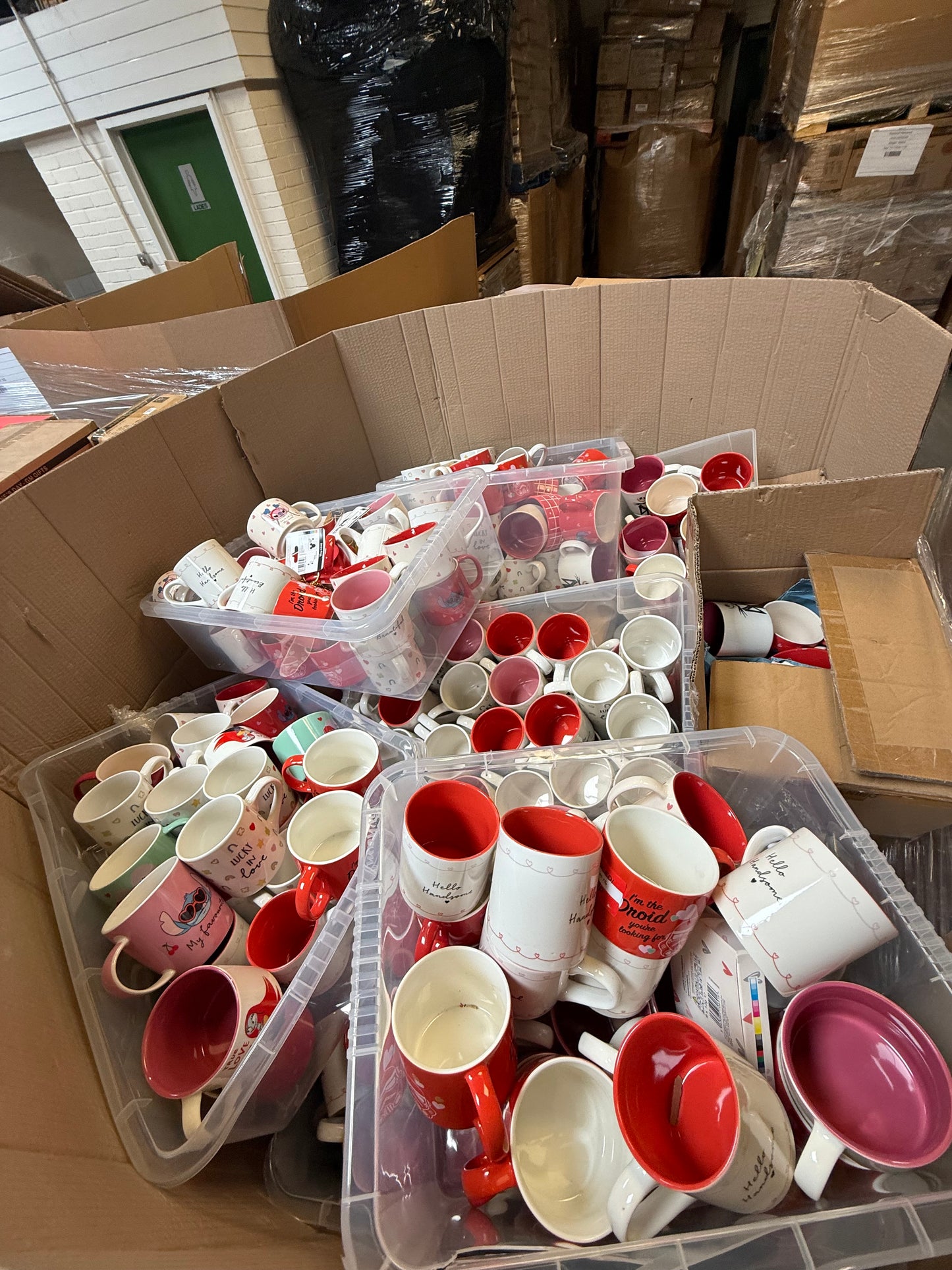 Seasonal mugs wholesale pallet filled with colorful mugs in various designs ready for retail