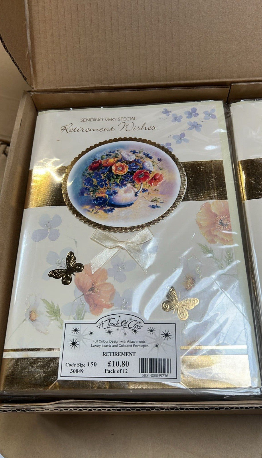 Box of floral retirement cards with gold foil accents packaged for sale bulk greeting cards wholesale
