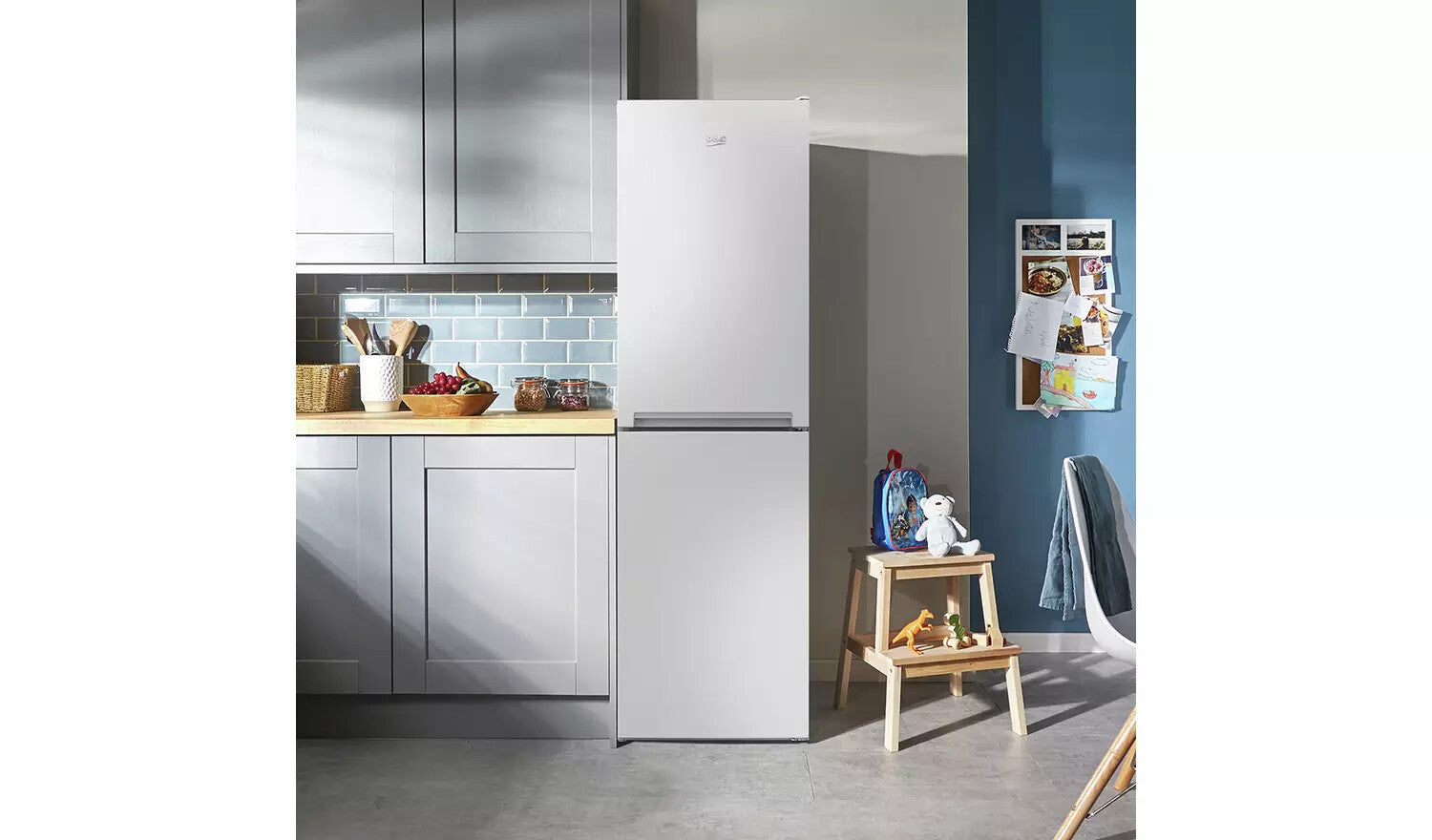 Beko CFG4582W frost free fridge freezer in a modern kitchen with grey cabinets and blue walls