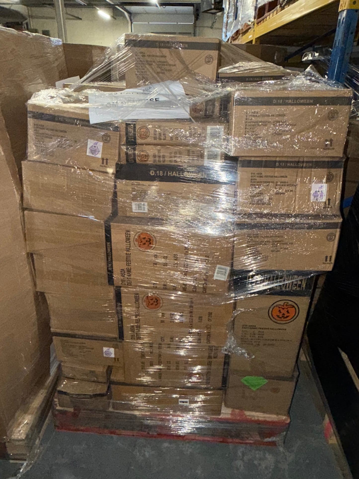 Bulk Halloween stock wholesale pallet stacked with sealed boxes for festive retail purposes