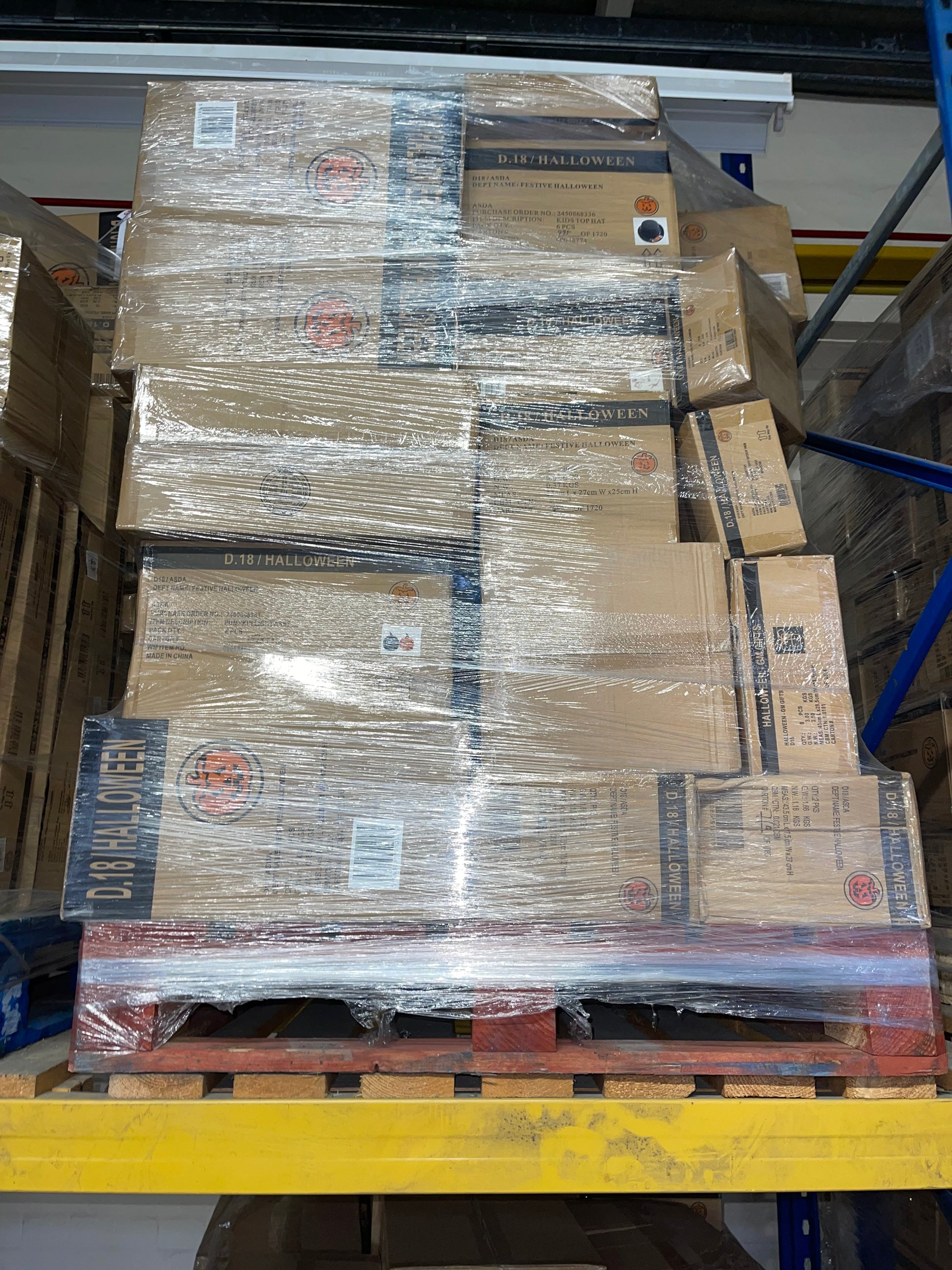 Halloween stock wholesale pallet stacked with boxed seasonal items ready for shipping