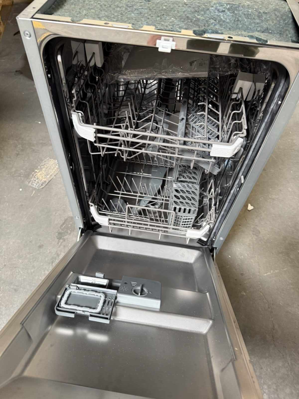 Ironbridge & Sons Ltd integrated slimline dishwasher with empty racks and control panel visible