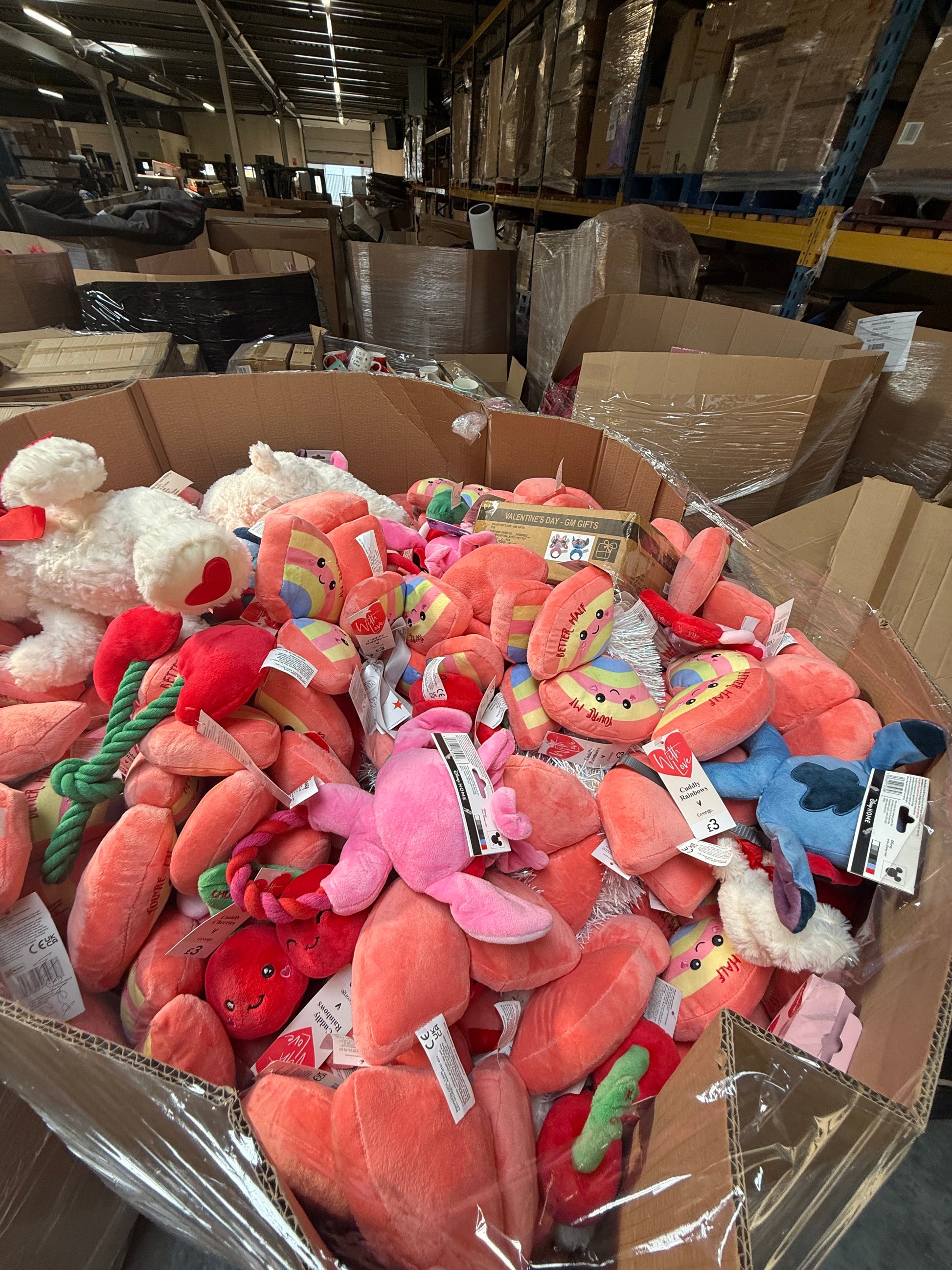 Bulk pallet of seasonal soft toys including various colorful plush items for retailers