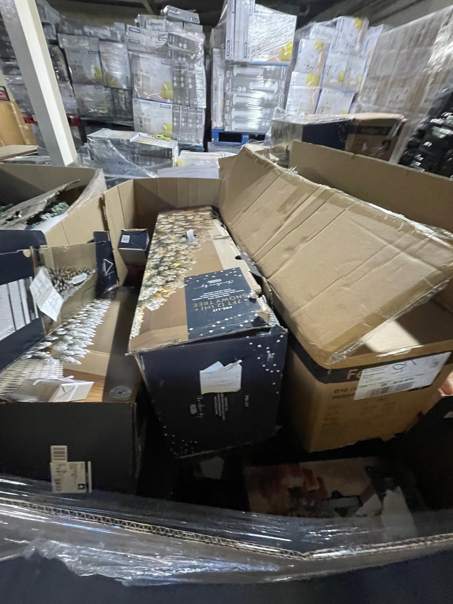 Bulk packing of wholesale Christmas tree pallets ready for distribution in a warehouse setting