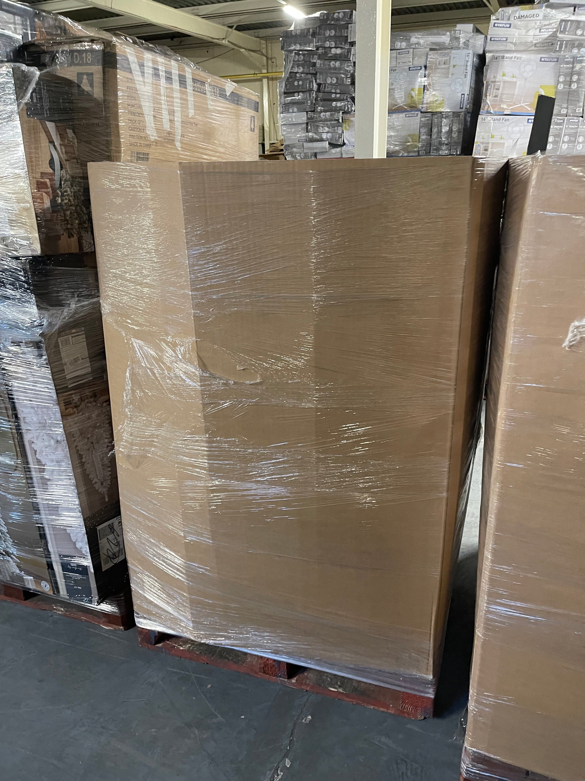 Wholesale Christmas tree pallets wrapped in stretch film for seasonal retail supply.