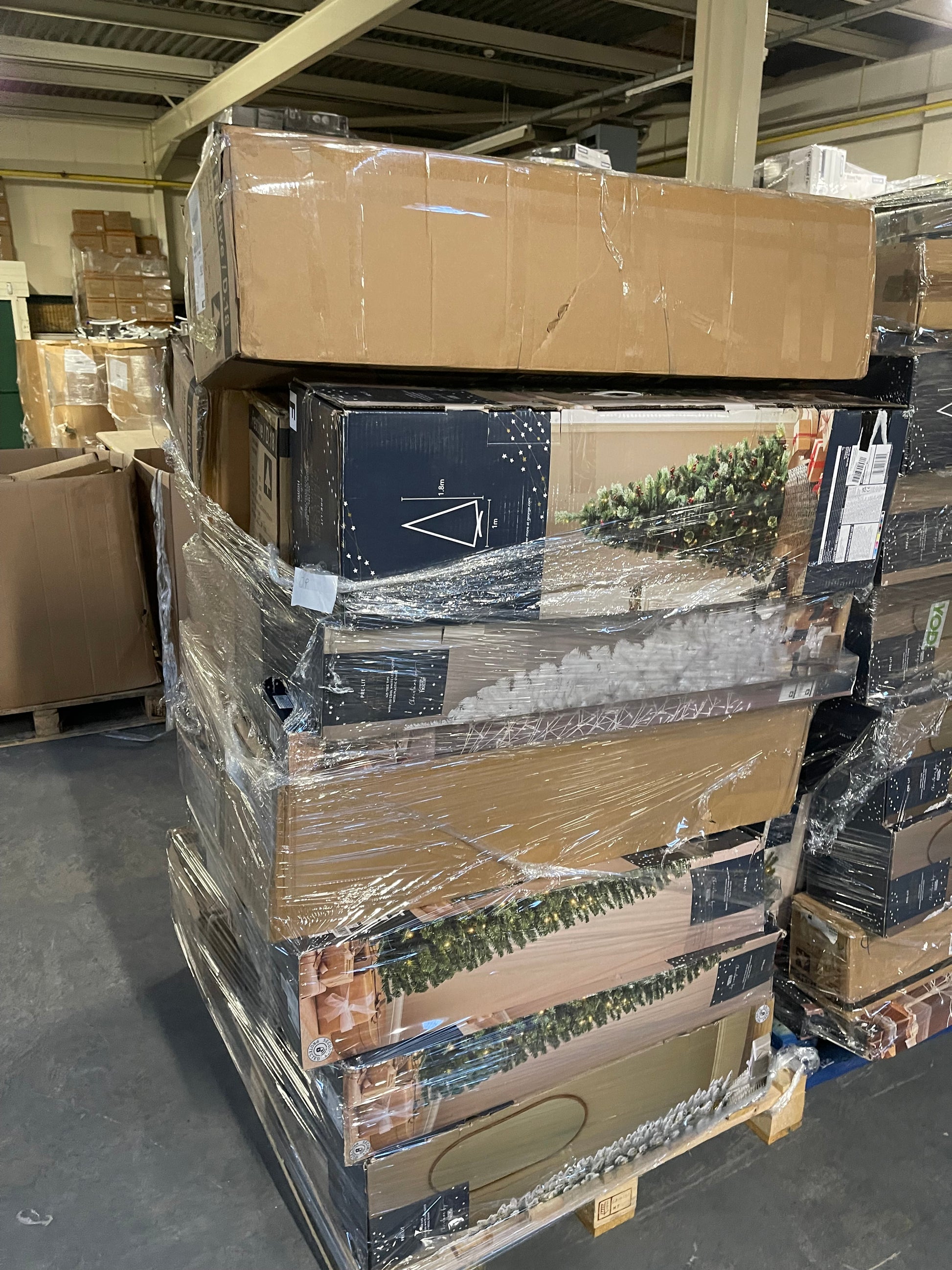 Warehouse stacked pallets of wholesale Christmas tree pallets for seasonal retail purposes